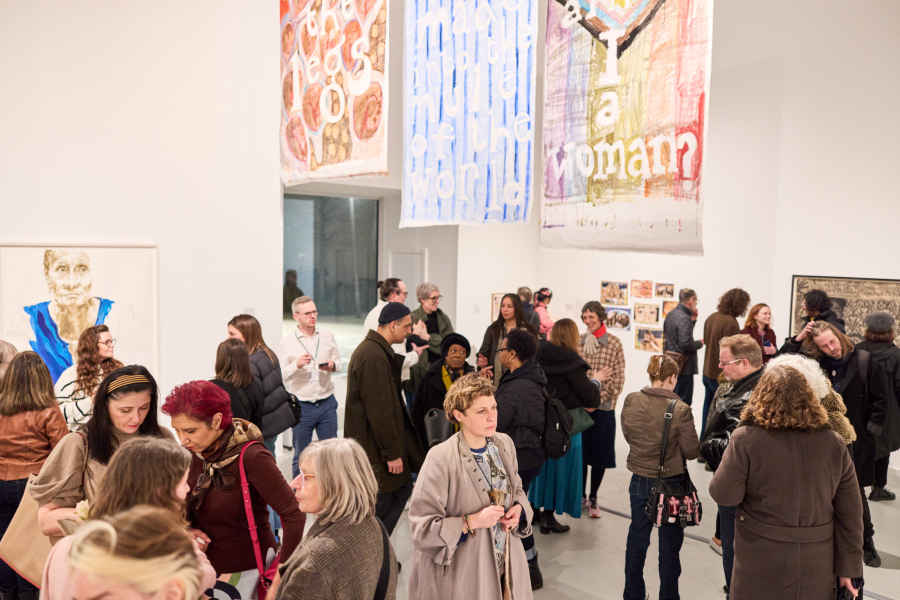 A wide shot of a crowd in a gallery